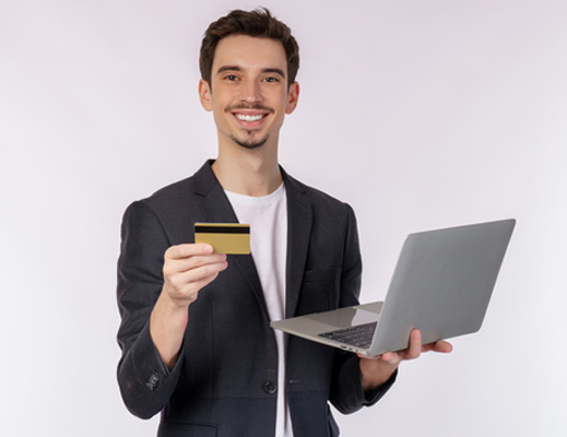 A man showing laptop and debit card